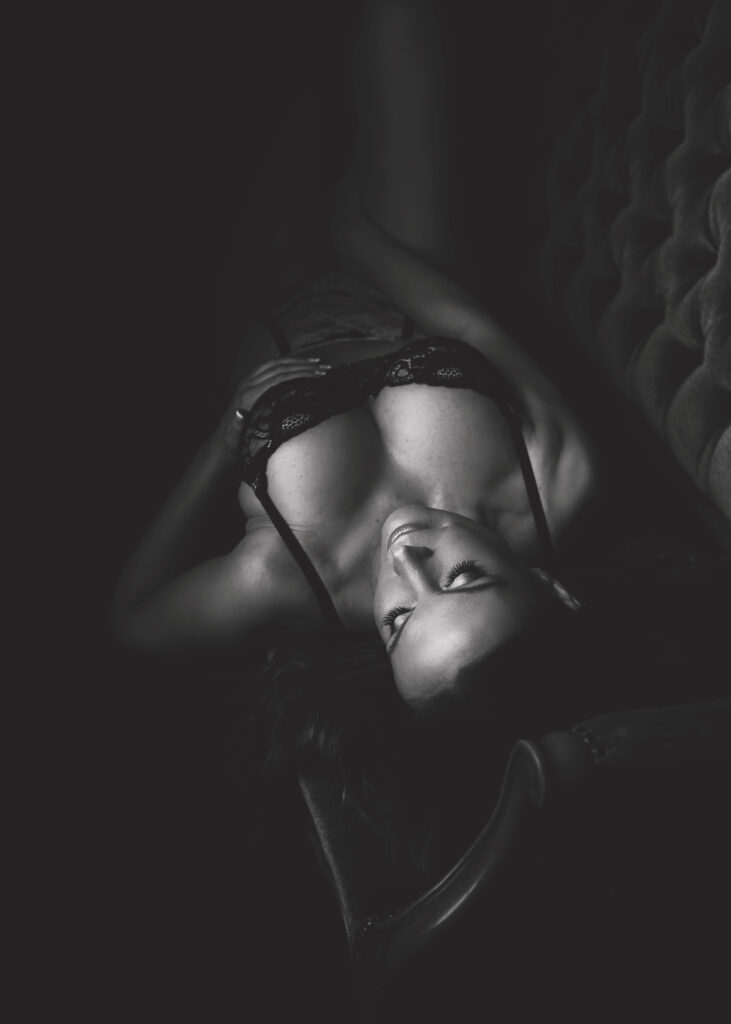 Black and white Boudoir photo of a woman in lingerie at Bradford Photography Studio