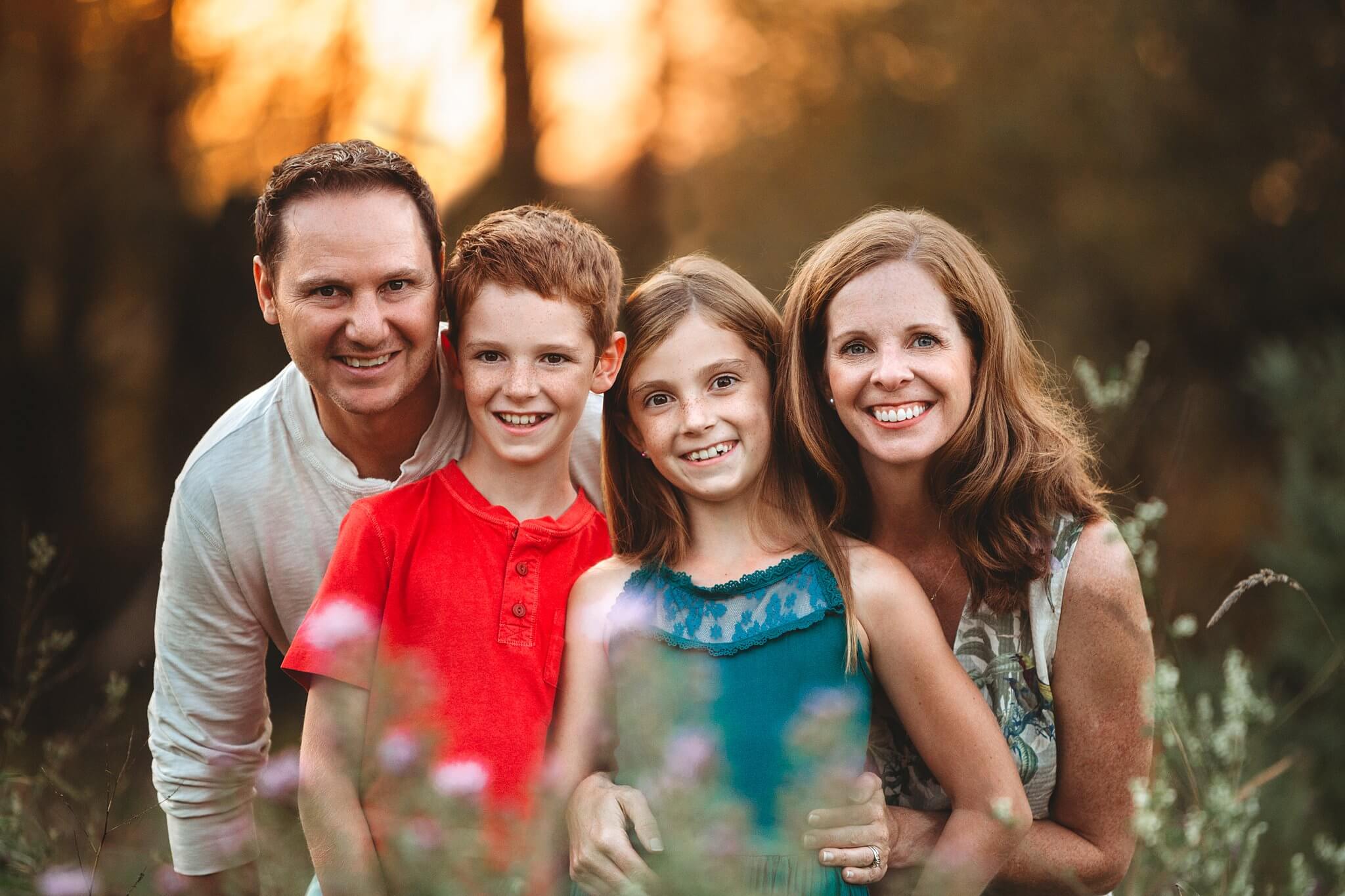 Close up portrait of a family of four at sunset