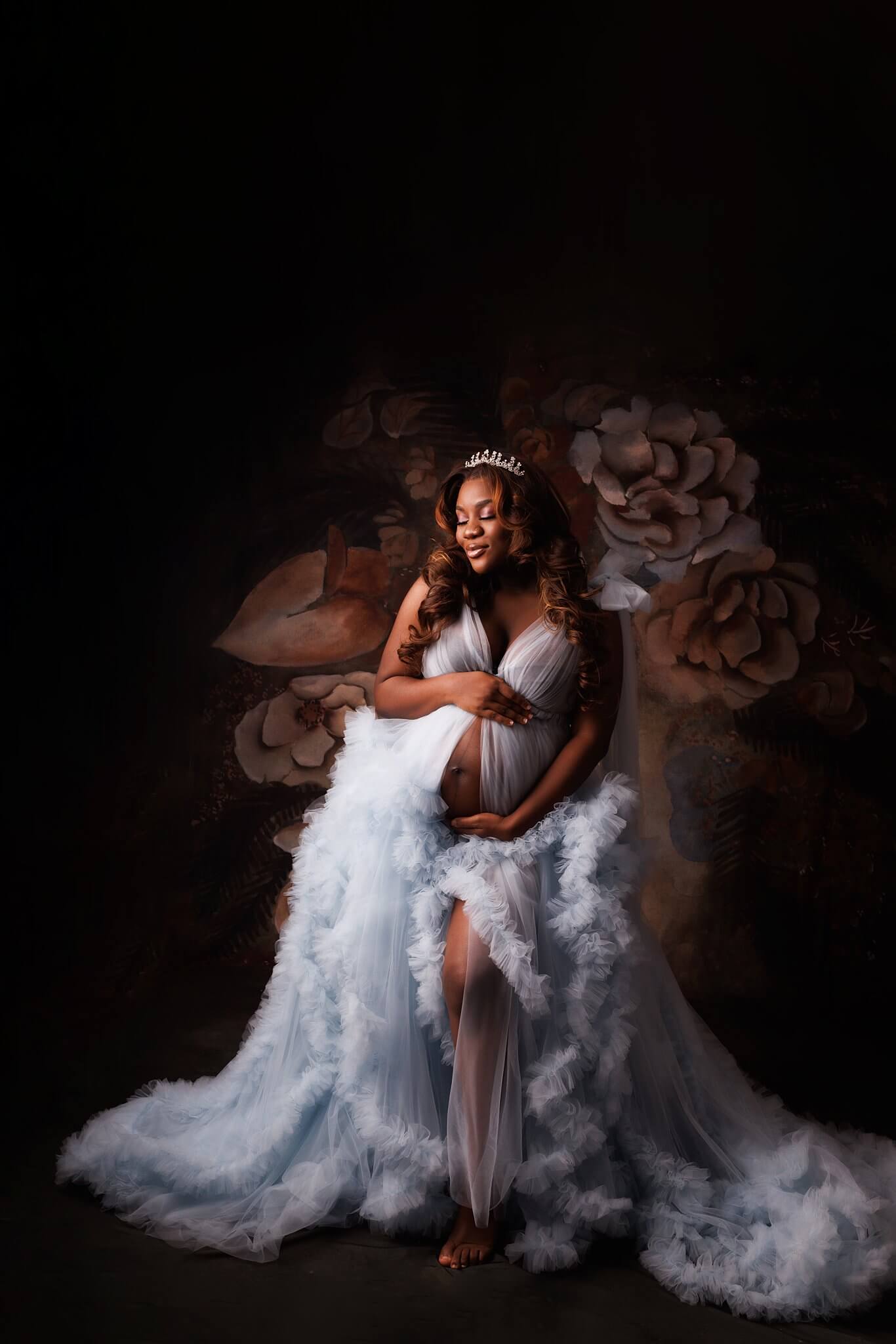 Beautiful expectant mother in a tiara and baby blue fluffy gown taken by Toronto Photographer