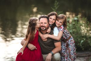 Family image of father with three daughters.