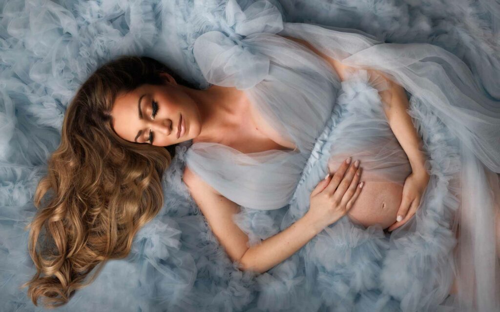 Gorgeous Mother to be lying in a pool of Baby Blue tulle by Toronto Maternity Photographer Shanna Parker