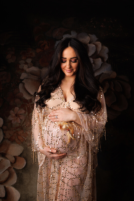 Beautiful Woman in a sparkly gold maternity gown by Toronto Maternity Photography Studio