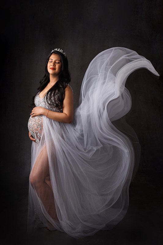 Maternity Photos Bradford studio dark haired mother in crown and silver flowing gown