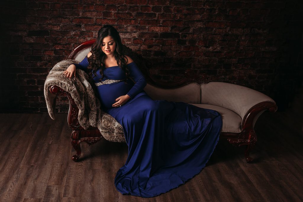 Maternity photo of woman on chaise lounge. Alliston Midwives
